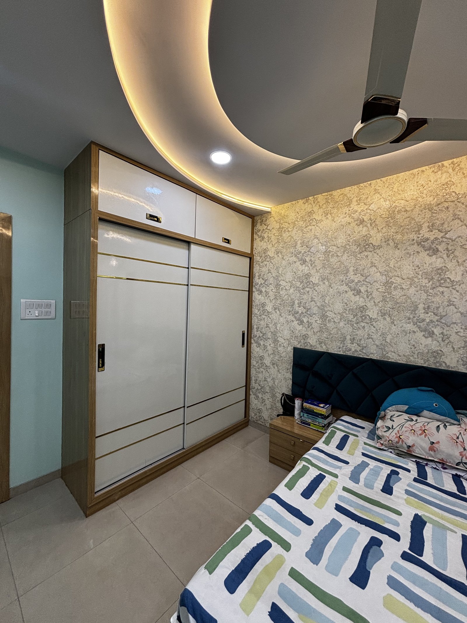Kids bedroom with fitted wardrobe and comfortable bed