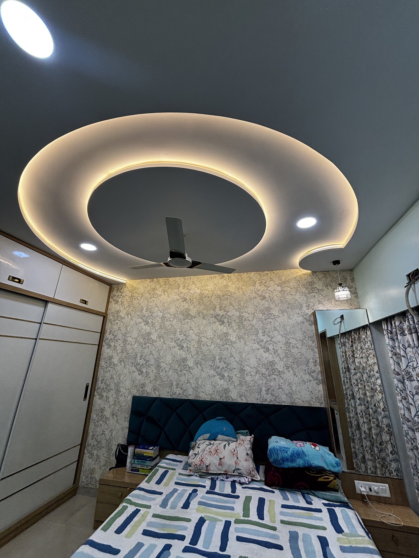 Kids bedroom with a softly lit ceiling and coordinated furnishings