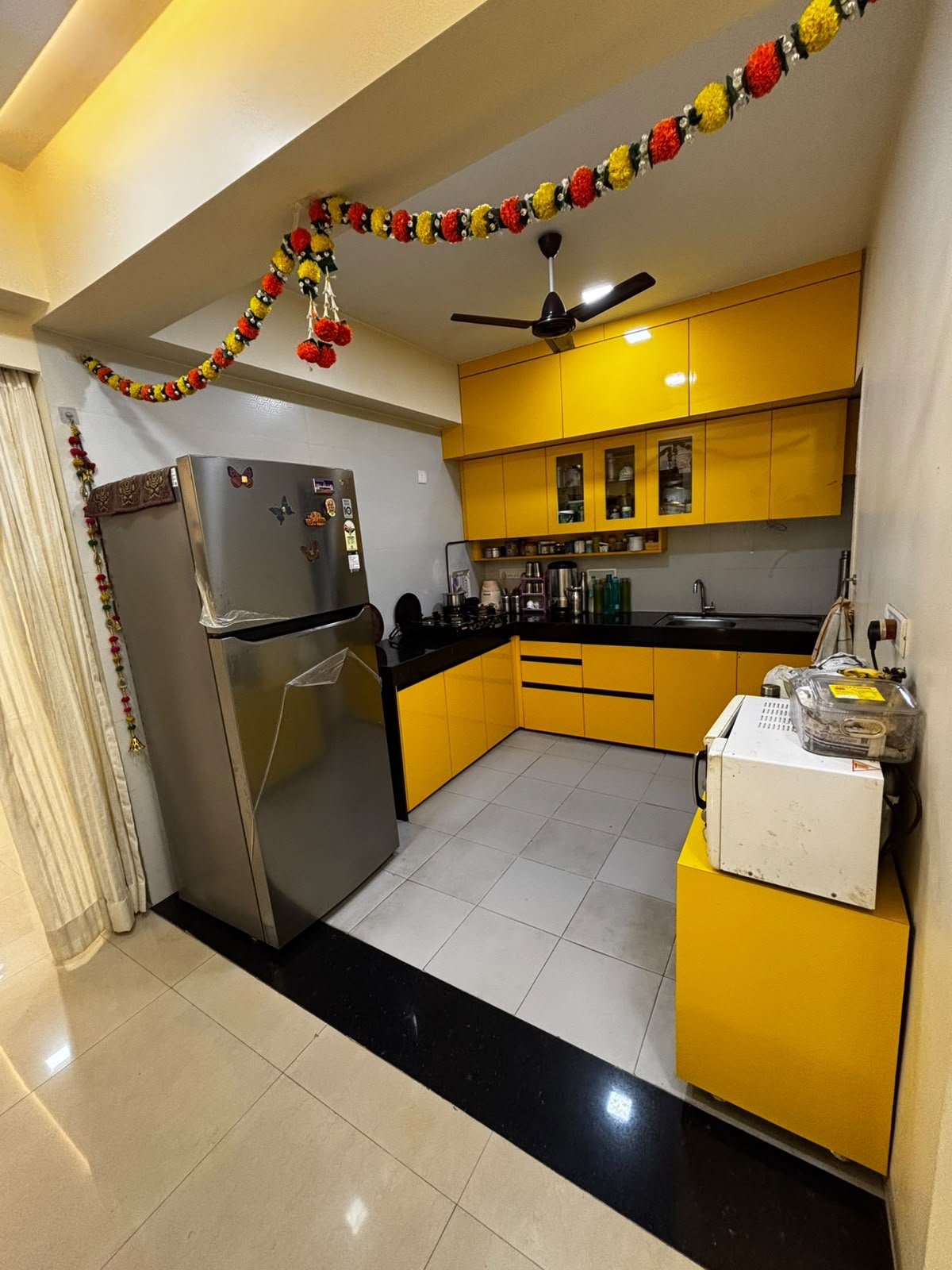 Complete yellow modular kitchen with fitted cabinets and appliances
