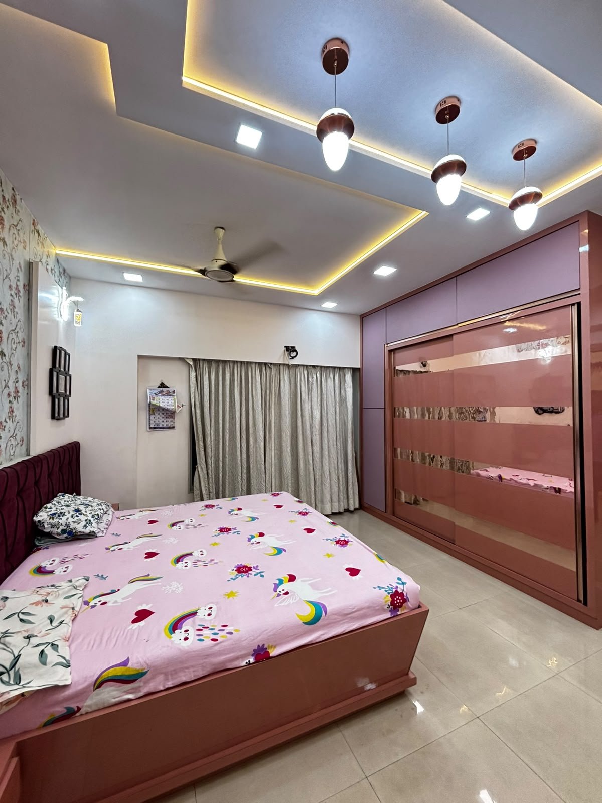 Master bedroom with coordinated finishes and a layered ceiling