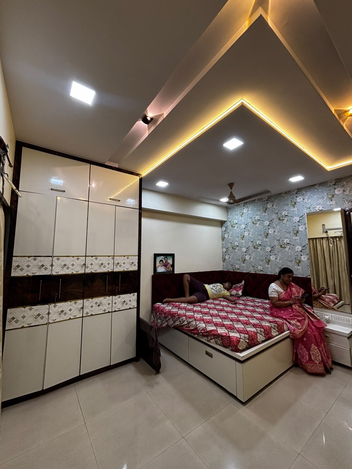 Complete parent bedroom with custom bed, wardrobe, and ambient ceiling lights