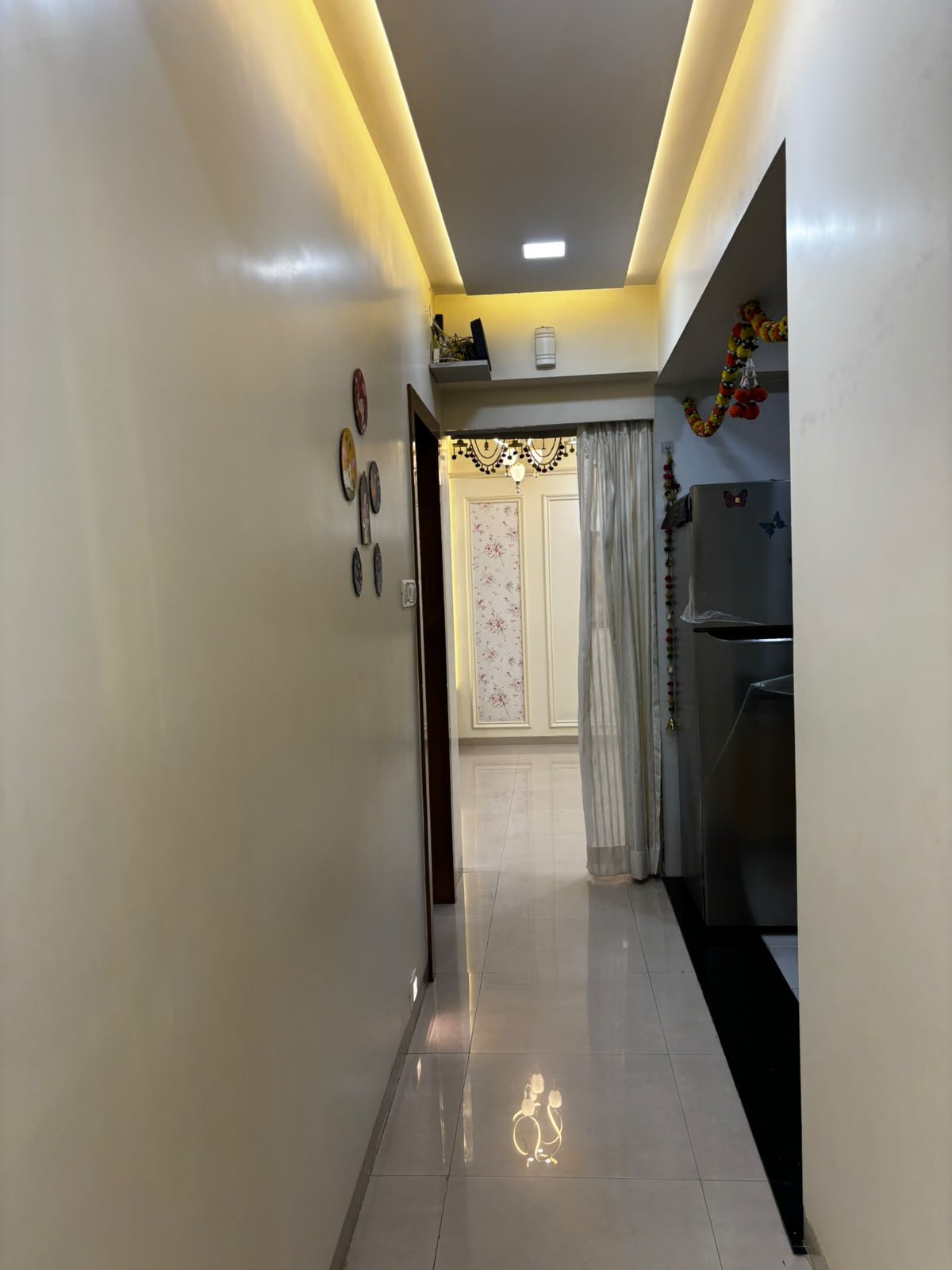 Warmly lit home passage with elegant ceiling details